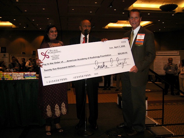 Singhs with giant check.jpg